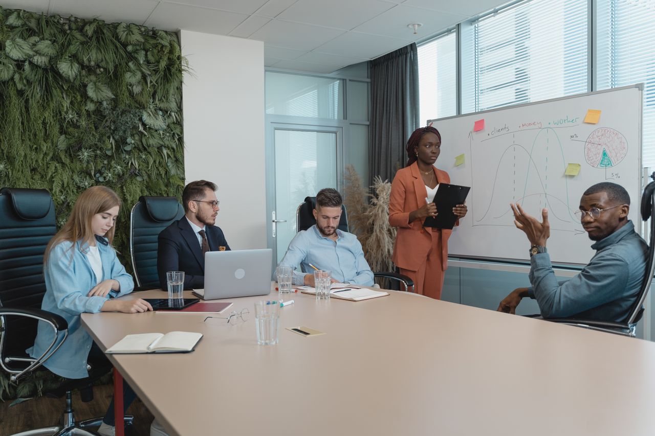 Diverse group of professionals engaged in an innovative brainstorming session in a modern office setting.